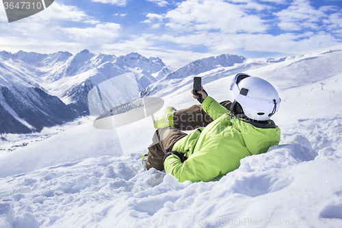 Image of Young men with smartphone mountain winter resort