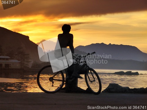 Image of Biker boy silhouette in sunset