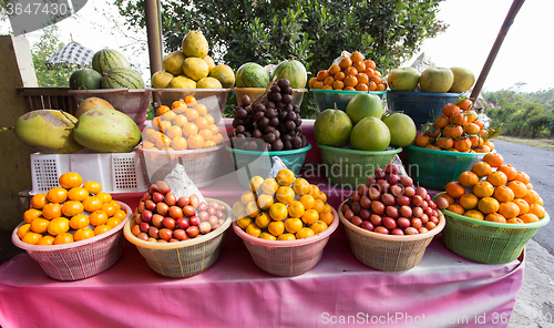 Image of tropical fruits in baskets on fruit market