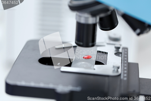 Image of close up of microscope and blood sample in lab