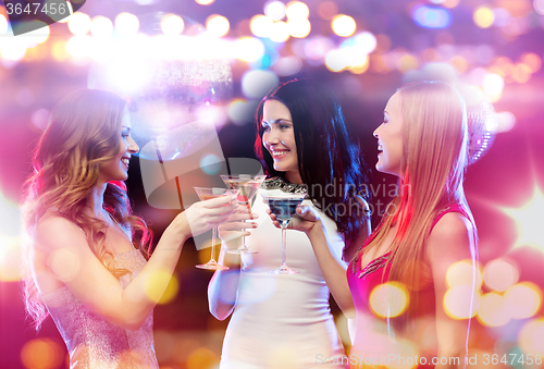 Image of smiling women with cocktails at night club