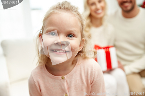 Image of happy family at home with christmas gift box