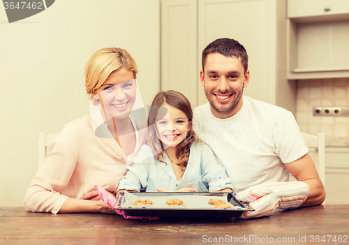 Image of happy family making cookies at home