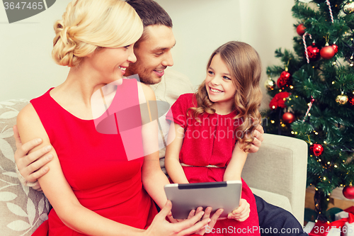 Image of smiling family with tablet pc