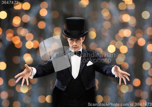 Image of magician in top hat showing trick