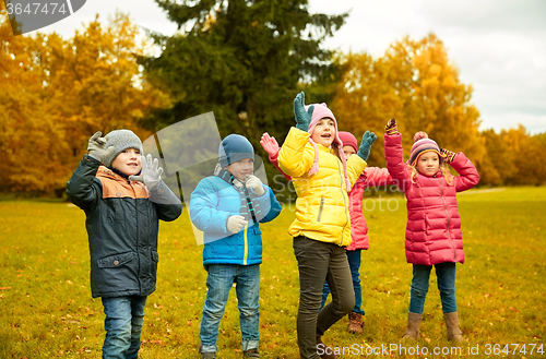 Image of group of happy children having fun in autumn park