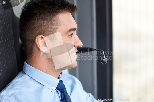 Image of happy bus driver face with microphone