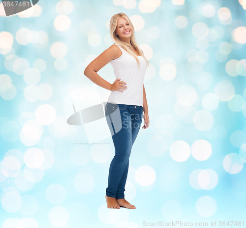 Image of smiling young woman in blank white shirt and jeans