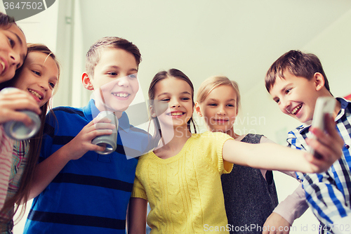 Image of group of school kids with smartphone and soda cans