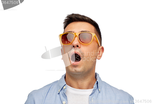 Image of face of scared man in shirt and sunglasses