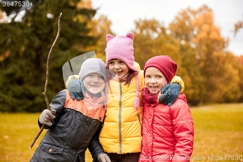 Image of group of happy children hugging in autumn park