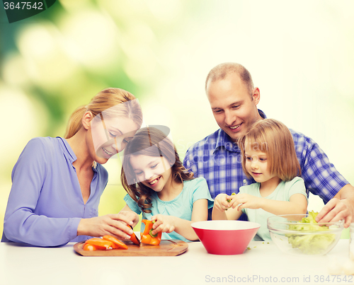 Image of happy family with two kids making dinner at home