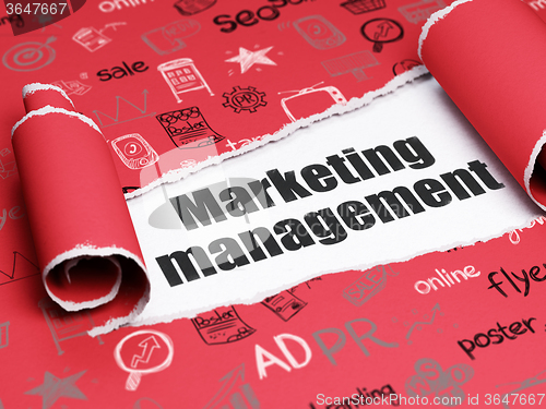 Image of Marketing concept: black text Marketing Management under the piece of  torn paper