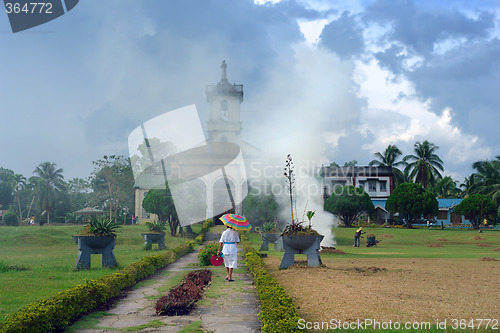 Image of Filipino village with churchgoer