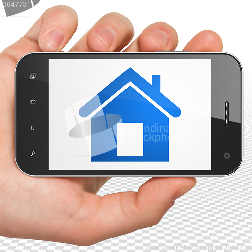 Image of Business concept: Hand Holding Smartphone with Home on display