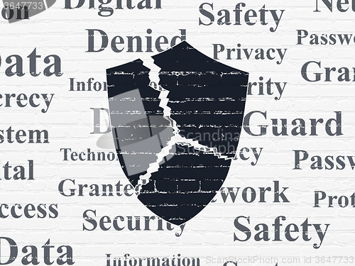 Image of Protection concept: Broken Shield on wall background