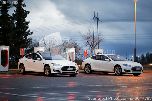 Image of Two Tesla Model S Cars Plugged in at Supercharger Station