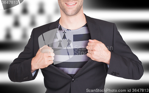 Image of Businessman opening suit to reveal shirt with flag