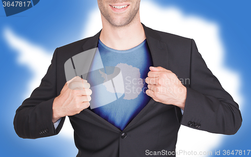 Image of Businessman opening suit to reveal shirt with flag