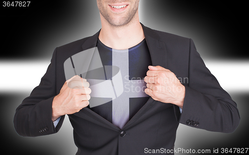 Image of Businessman opening suit to reveal shirt with flag