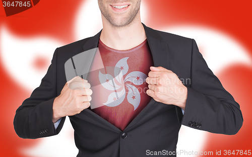 Image of Businessman opening suit to reveal shirt with flag