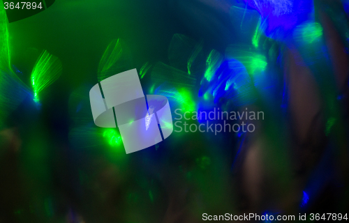 Image of blue green night lights bokeh over dark background