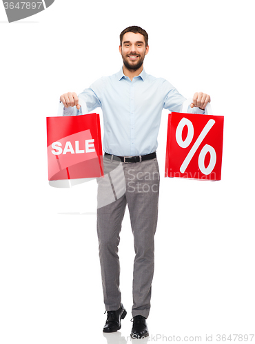 Image of smiling man with red shopping bag