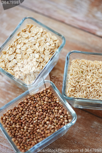 Image of close up of grain in glass bowls on wooden table