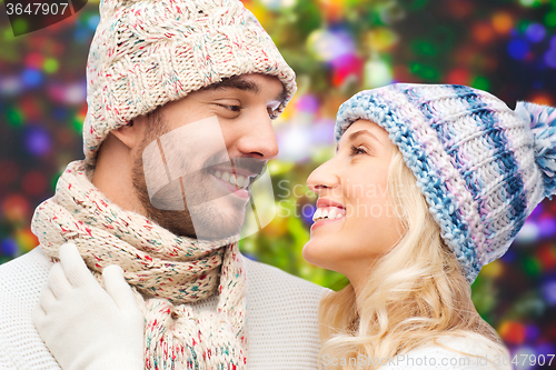 Image of smiling couple in winter clothes hugging