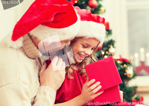 Image of smiling father and daughter opening gift box