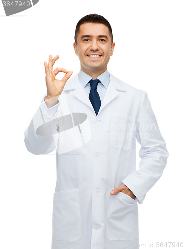 Image of smiling doctor in white coat showing ok hand sign