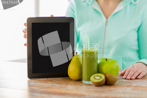 Image of close up of woman hands tablet pc and fruit juice