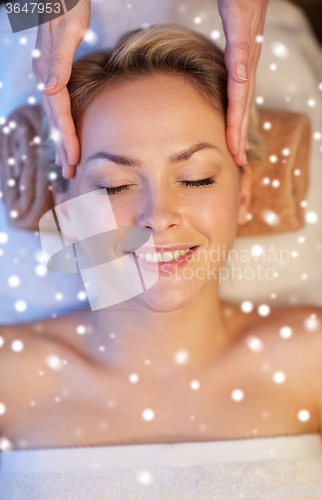 Image of close up of woman having face massage in spa salon