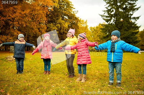 Image of happy little children running and playing outdoors