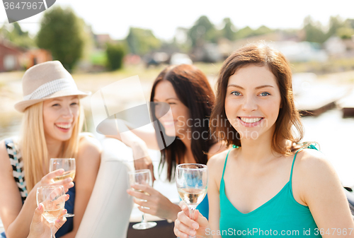 Image of smiling girls with champagne glasses