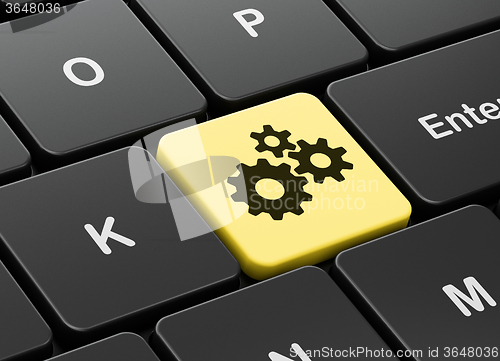 Image of Advertising concept: Gears on computer keyboard background