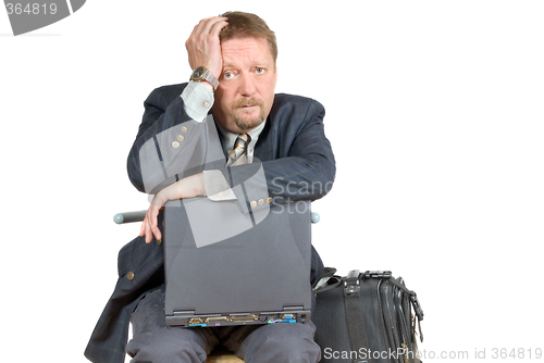 Image of Unhappy traveling businessman.
