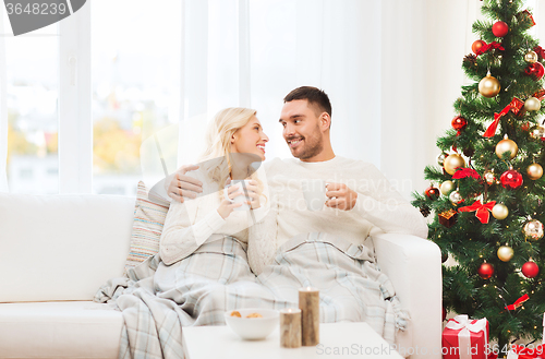 Image of happy couple at home with christmas tree