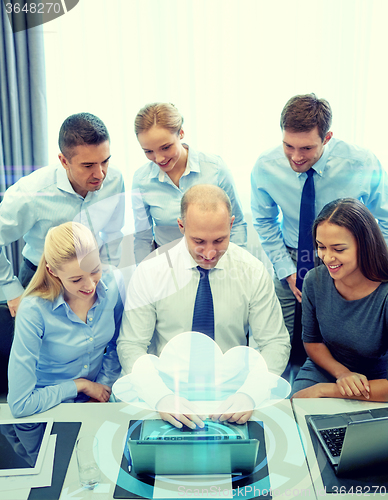 Image of smiling business people with laptop in office