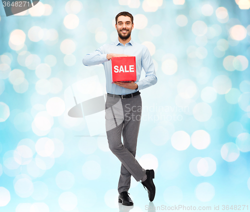 Image of smiling man with red shopping bag