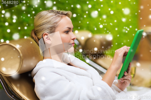 Image of beautiful young woman with  tablet pc at spa