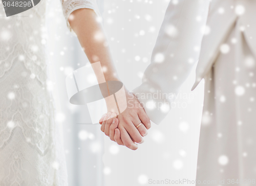 Image of close up of happy married lesbian couple hugging