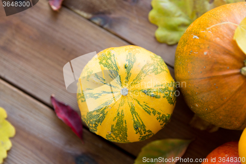 Image of close up of pumpkins on wooden table at home