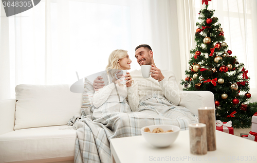 Image of happy couple at home with christmas tree