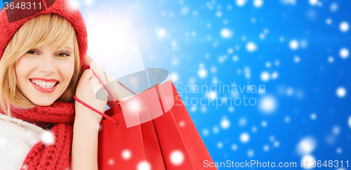 Image of smiling young woman with shopping bags