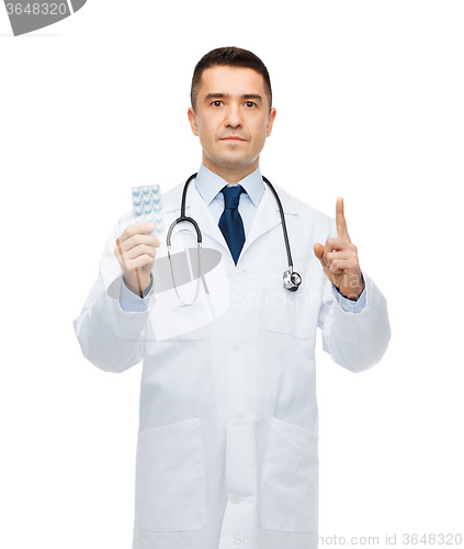 Image of male doctor in white coat with tablets