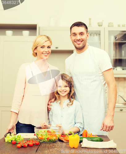 Image of happy family making dinner in kitchen