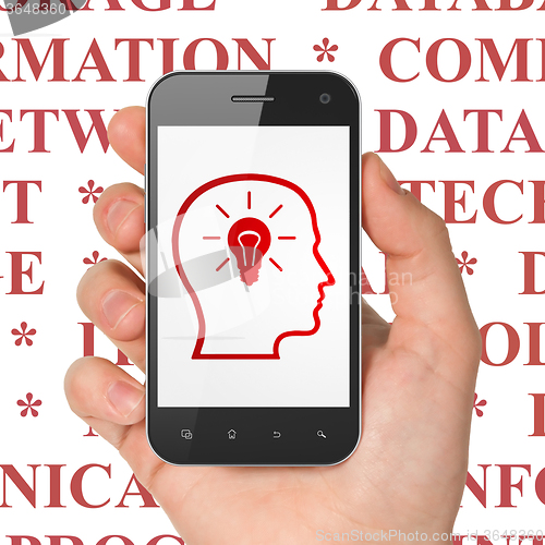 Image of Information concept: Hand Holding Smartphone with Head With Lightbulb on display
