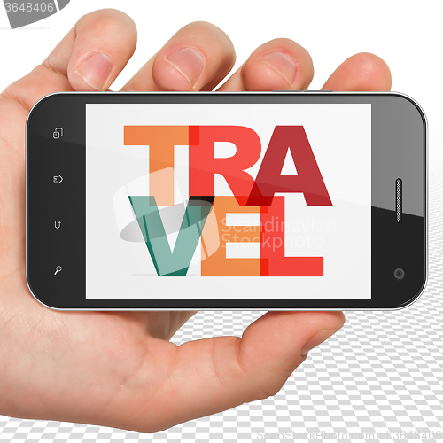 Image of Tourism concept: Hand Holding Smartphone with Travel on  display