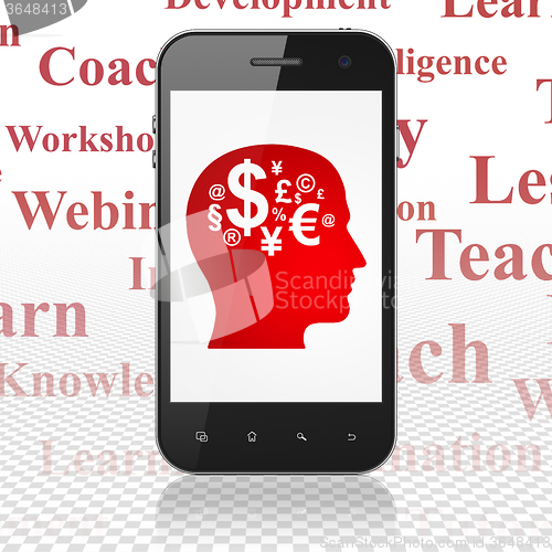 Image of Education concept: Smartphone with Head With Finance Symbol on display